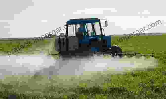 A Tractor Mounted Duster Applying Powder Based Pesticides To A Field Of Crops. Farm Machinery For Spraying And Dusting Crops